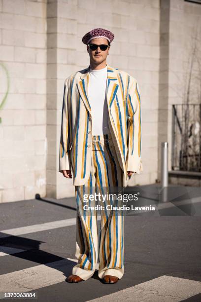 Guido Milani poses ahead of the Marni fashion show wearing black sunglasses and a beige, yellow and bue suit during the Milan Fashion Week...