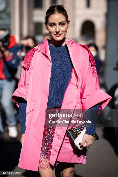 Olivia Palermo poses ahead of the Ermanno Scervino fashion show wearing a a pink oversized short sleeves coat, a blue wool pullover and a fuchsia...