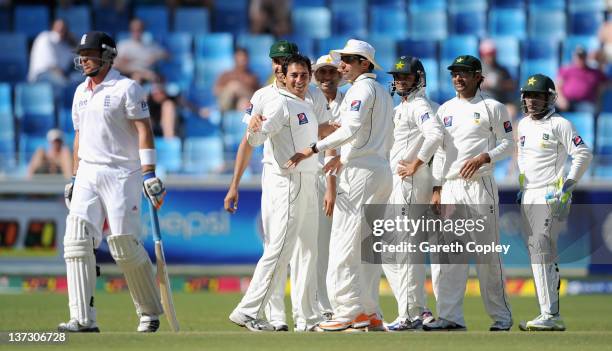 Saeed Ajmal of Pakistan celebrates with teammates after dismissing Ian Bell of England during the first Test match between Pakistan and England at...