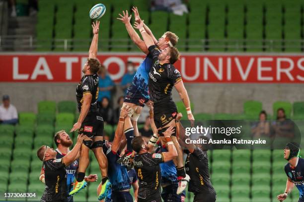 Reece Hodge of the Rebels attempts to win the line out as he is contested by Tim Anstee and Izack Rodda of the Force during the round two Super Rugby...