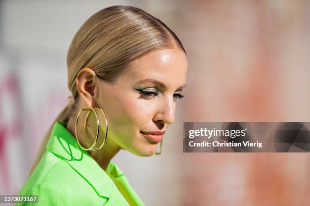 Leonie Hanne is seen wearing green blazer, top, knee high boots, golden earrings outside Marni fashion show during the Milan Fashion Week Fall/Winter...