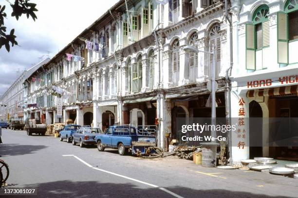 historical photo of a shopping street in jalan besar, an old district of singapore, taken in 1989. - singapore alley stock pictures, royalty-free photos & images