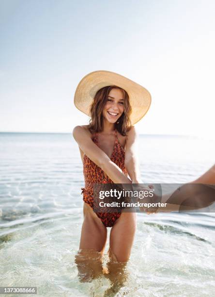 happiness friends at the seaside with panama hat - couple swimwear stock pictures, royalty-free photos & images