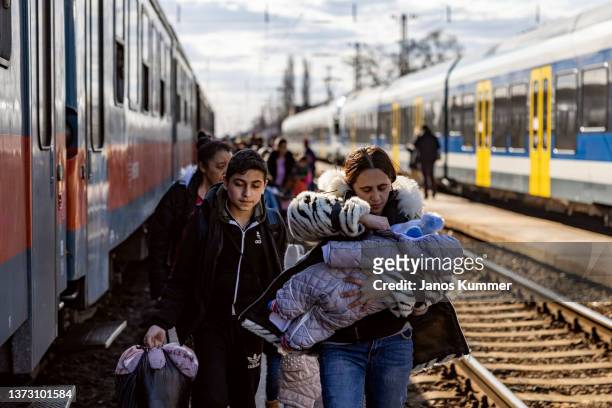 Hundreds of people arrive to the train station after crossing the border at Zahony-Csap as they flee Ukraine on February 27, 2022 in Zahony, Hungary....