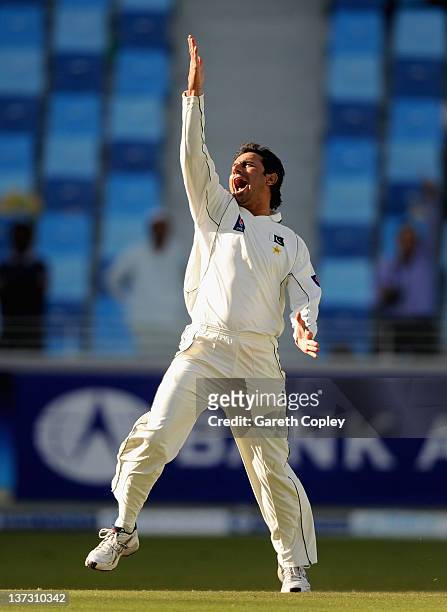 Saeed Ajmal of Pakistan celebrates dismissing Matt Prior of England during the first Test match between Pakistan and England at The Dubai...