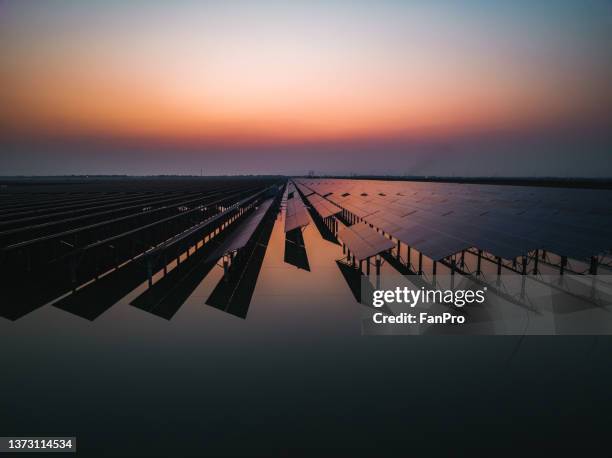 solar power plant at sunset - transformator stock-fotos und bilder