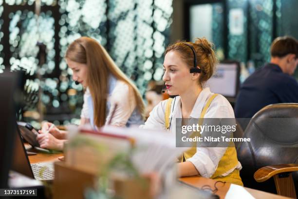 back office support outsourcing services for business process. office employee using computers busy working in business office. - global business continuity stock pictures, royalty-free photos & images