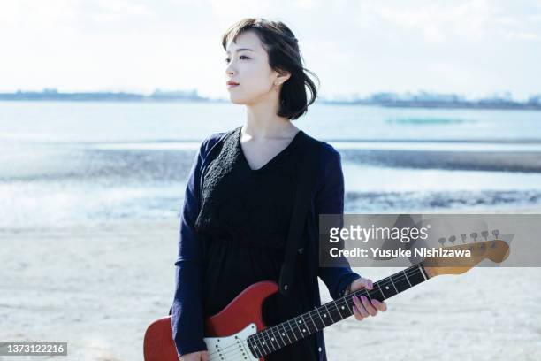 woman with guitar - woman electric guitar stock pictures, royalty-free photos & images