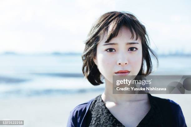 woman looking at camera with serious face - front looking asian women stock pictures, royalty-free photos & images