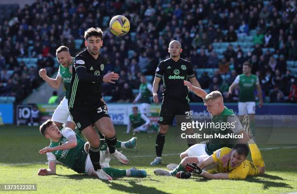 Matt Macey of Hibernian makes a save from Matt O'Riley of Celtic during the Cinch Scottish Premiership match between Hibernian FC and Celtic FC at on...