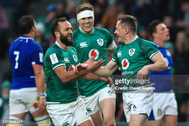 Michael Lowry celebrates with Jamison Gibson-Park and Garry Ringrose of Ireland after scoring their sides third try during the Six Nations Rugby...