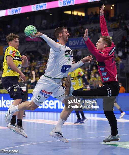 Felix Danner of Wetzlar scores a goal against goalkeeper Joel Birlehm of Rhein-Neckar Loewen during the LIQUI MOLY HBL match between Rhein-Neckar...