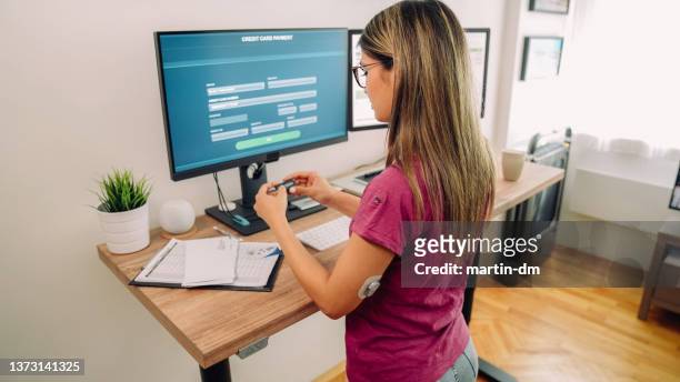 woman working at standing desk - token stock pictures, royalty-free photos & images