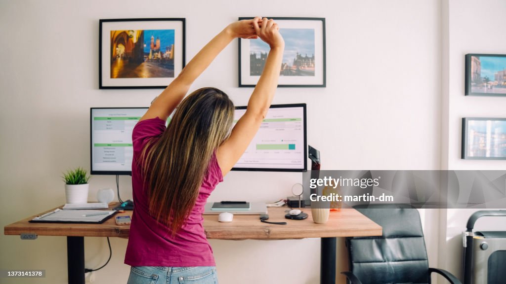 Young woman with diabetes working at standing desk