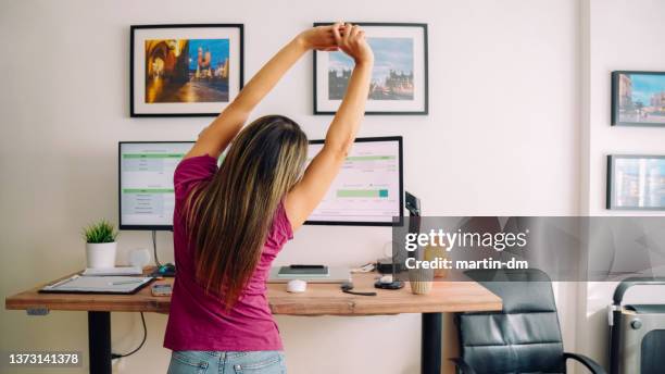 Young Woman With Diabetes Working At Standing Desk High-Res Stock Photo