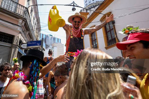 People part of carnival troupe celebrates Carnival Sunday in the downtown area on February 27, 2022 in Rio de Janeiro, Brazil. With the traditional...