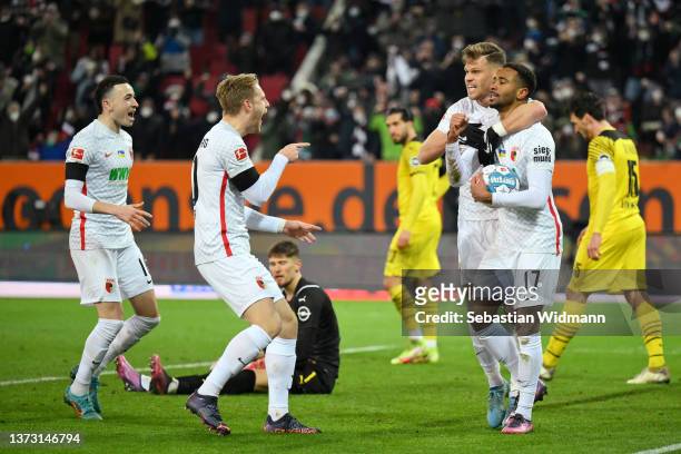 Noah-Joel Sarenren-Bazee celebrates with Ruben Vargas Martinez, Arne Maier and Florian Niederlechner of FC Augsburg after scoring their team's first...