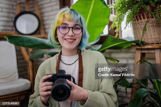 portrait of a young smiling photographer - portrait of cool creative businesswoman at office bildbanksfoton och bilder