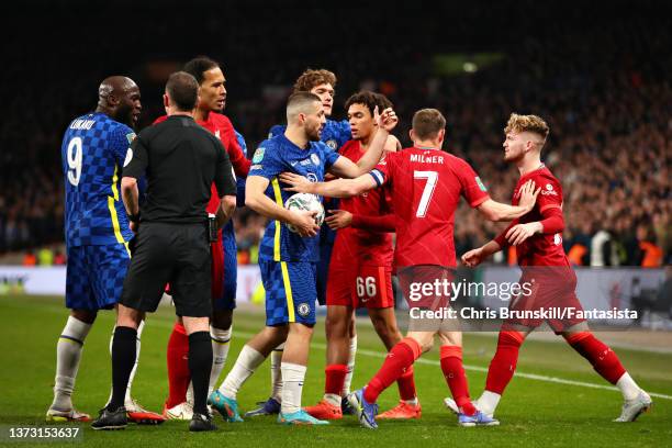 Referee Stuart Attwell attempts to diffuse a situation between Chelsea and Liverpool players during the Carabao Cup Final match between Chelsea and...