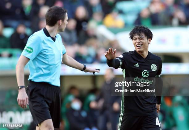 Reo Hatate of Celtic interacts with Referee Kevin Clancey during the Cinch Scottish Premiership match between Hibernian FC and Celtic FC at on...