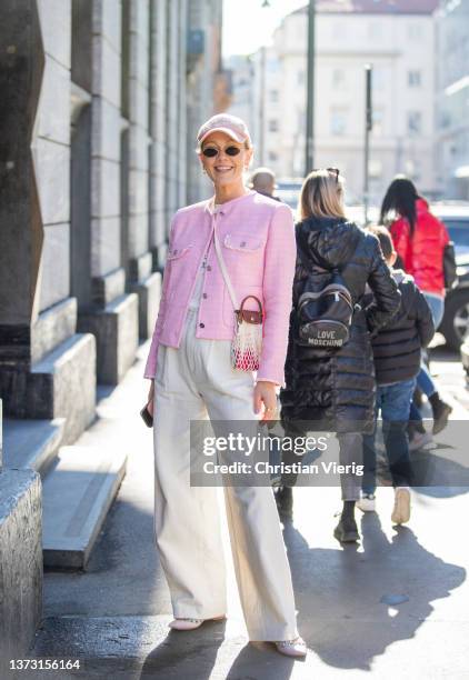 Kate Gelinsky is seen wearing pink jacket, creme white pants, bag, cap outside Ermanno Scervino fashion show during the Milan Fashion Week...