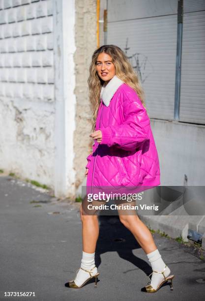 Emili Sindlev wearing pink shearling jacket puffer skirt, ankle boots seen outside Marni fashion show during the Milan Fashion Week Fall/Winter...