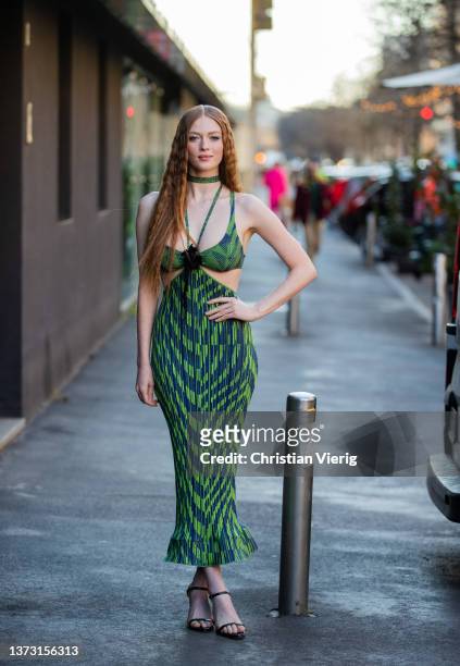 Larsen Thompson is seen wearing a green and navy blue print pattern N-neck / tank-top / necklace / cut-out waist / tube long dress, black shiny...