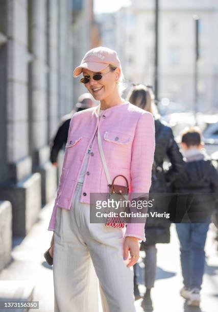Kate Gelinsky is seen wearing pink jacket, creme white pants, bag, cap outside Ermanno Scervino fashion show during the Milan Fashion Week...