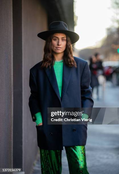 Erika Boldrin seen wearing hat, navy double breasted blazer, green glitter pants with black graphic print, green knitted jumper, necklace outside...