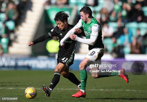 Reo Hatate of Celtic vies with Drey Wright of Hibernian during the Cinch Scottish Premiership match between Hibernian FC and Celtic FC at on February...