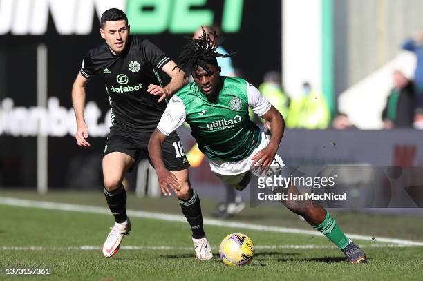 Tom Rogic of Celtic vies with Rocky Bushiri of Hibernian during the Cinch Scottish Premiership match between Hibernian FC and Celtic FC at on...