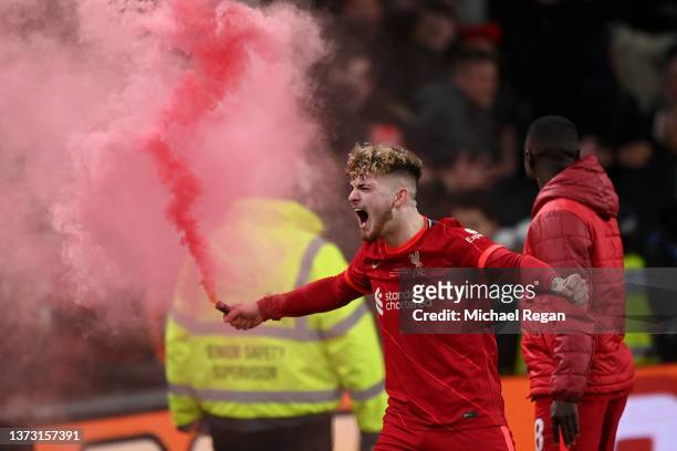 Harvey Elliott of Liverpool celebrates with a red flare following their team's victory in the penalty shoot out during the Carabao Cup Final match...