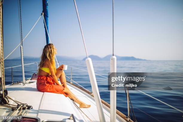 young attractive woman enjoying at sunny day on yacht - sail boat stock pictures, royalty-free photos & images