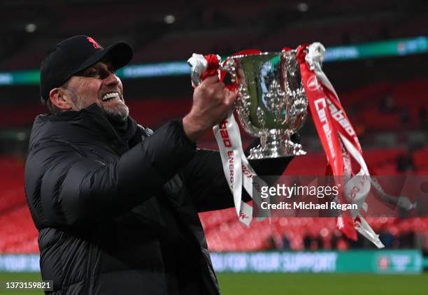 Juergen Klopp of Liverpool lifts The Carabao Cup trophy following their side's victory during the Carabao Cup Final match between Chelsea and...