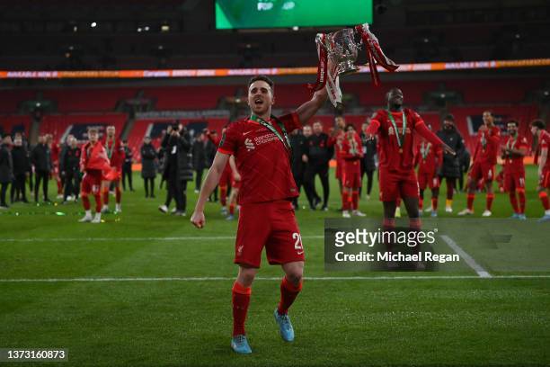 Diogo Jota of Liverpool celebrates with the Carabao Cup trophy following victory in the Carabao Cup Final match between Chelsea and Liverpool at...