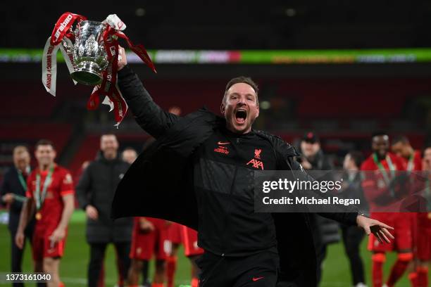 Pepijn Lijnders, Assistant Manager of Liverpool celebrates with the Carabao Cup trophy following victory in the Carabao Cup Final match between...