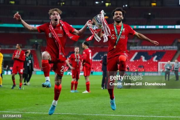 Kostas Tsimikas and Mohamed Salah of Liverpool celebrate with the trophy after the Carabao Cup Final match between Chelsea and Liverpool at Wembley...
