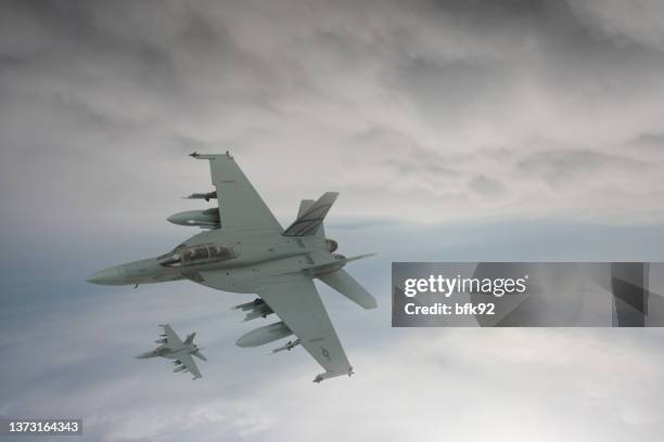 jet fighters flying over the clouds. - gevechtsvliegtuig stockfoto's en -beelden