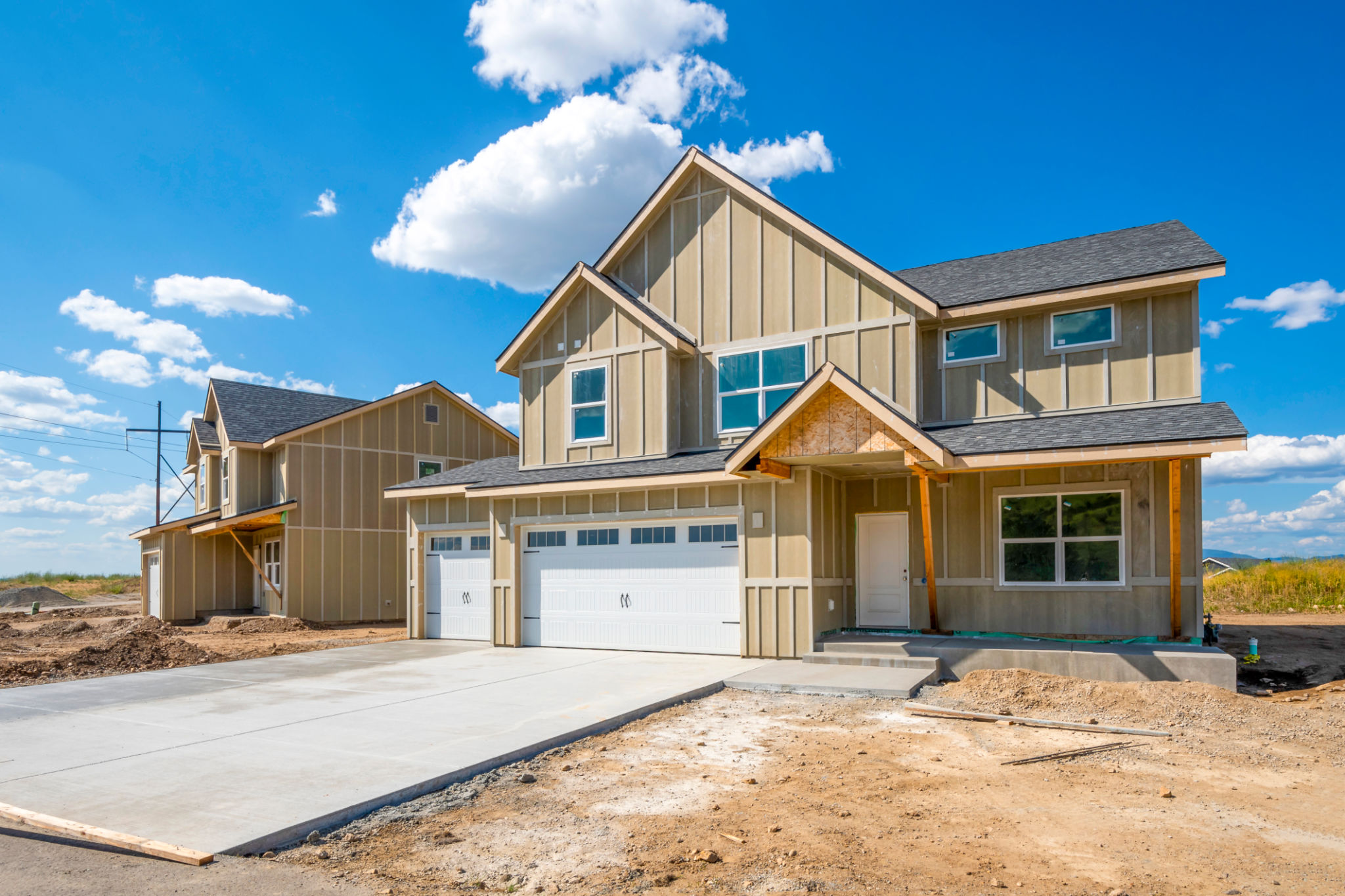 A street of partially finished new homes in a new suburban housing development in Spokane, Washington, USA. A street of partially finished new homes in a new suburban housing development in Spokane, Washington, USA.
