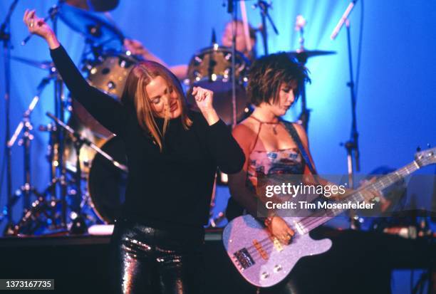 Belinda Carlisle and Kathy Valentine of The Go-Go's perform at Shoreline Amphitheatre on July 31, 2000 in Mountain View, California.