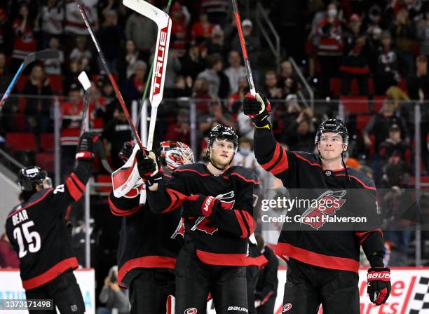 The Carolina Hurricanes celebrate with their traditional "Storm Surge" after a win against the Edmonton Oilers at PNC Arena on February 27, 2022 in...