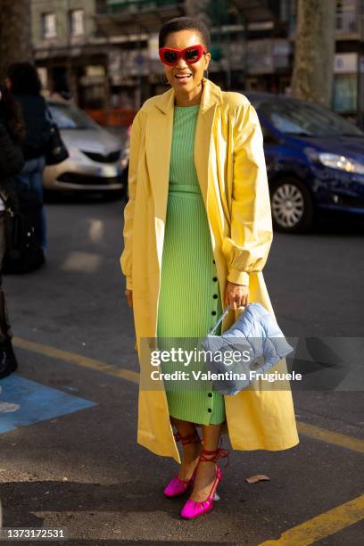 Tamu McPherson is seen ahead of the MSGM fashion show wearing a yellow coat and green ribbed dress during the Milan Fashion Week Fall/Winter...