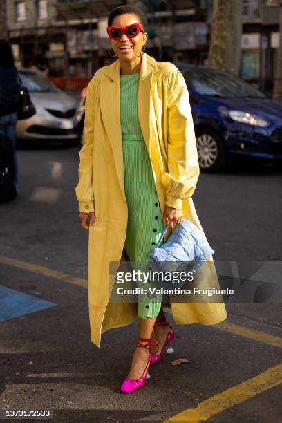 Tamu McPherson is seen ahead of the MSGM fashion show wearing a yellow coat and green ribbed dress during the Milan Fashion Week Fall/Winter...