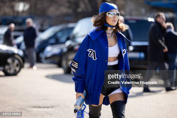Karina Nigay is seen ahead of the Dsquared2 fashion show wearing high thigh boots, varsity jacket and a bandana during the Milan Fashion Week...