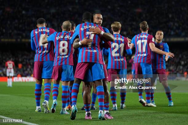 Memphis Depay of FC Barcelona celebrates with teammate Ousmane Dembele after scoring their team's fourth goal during the LaLiga Santander match...