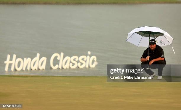 Shane Lowry of Ireland lines up a putt on the 18th green during the final round of The Honda Classic at PGA National Resort And Spa on February 27,...