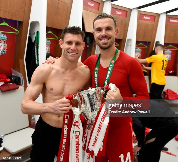James Milner and Jordan Henderson captain of Liverpool in the dressing room with the EFL Carabao Cup trophy at the end of the Carabao Cup Final match...