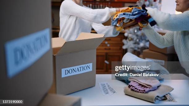 preparing donation boxes during the winter holidays. christmas charity. - giving tuesday stock pictures, royalty-free photos & images