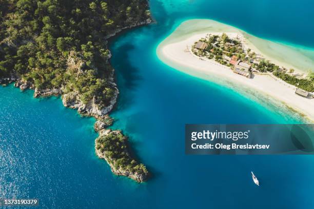 aerial drone view of oludeniz blue lagoon with turquoise sea, paradise white sand beach and tourist boat - fethiye imagens e fotografias de stock
