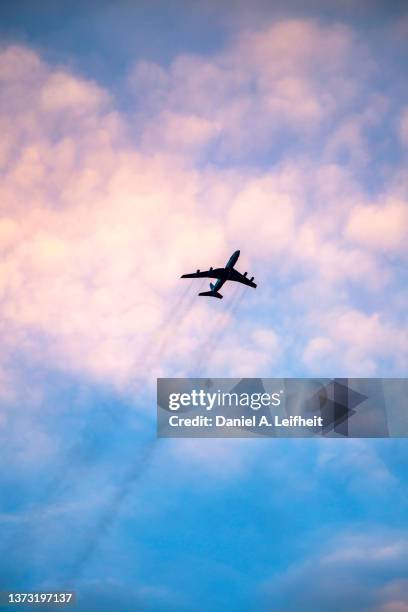 u.s. air force boeing e-3 sentry awacs jet in flight at sunset - wind direction stock pictures, royalty-free photos & images